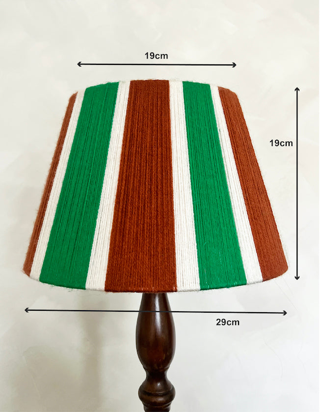 A striped Slice Shades yarn lampshade on a dark wooden lamp stand, with measurement arrows and labels showing dimensions of 19cm width, 19cm height, and 29cm base diameter against a plain light background.