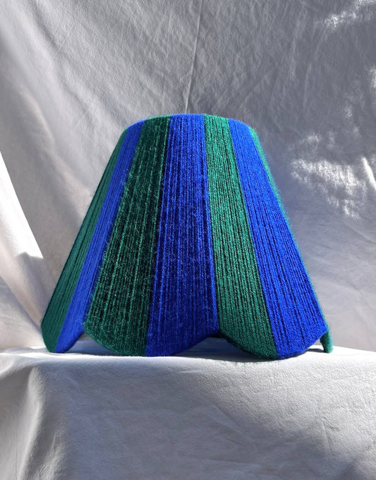 A Slice Shades handwoven yarn striped Scallop Lampshade in the sun in Cobalt Blue & Forest Green.