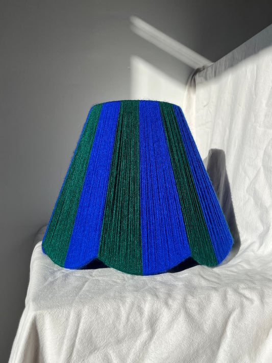 A Slice Shades handwoven yarn striped Scallop Lampshade in the sun in Cobalt Blue & Emerald Green.