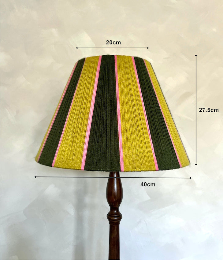 A Slice Shades yarn lampshade with vertical stripes in olive green, mustard yellow, and pink, shown on a dark wooden lamp stand with overlaid dimension lines and text indicating 20cm width, 27.5cm height, and 40cm base width.